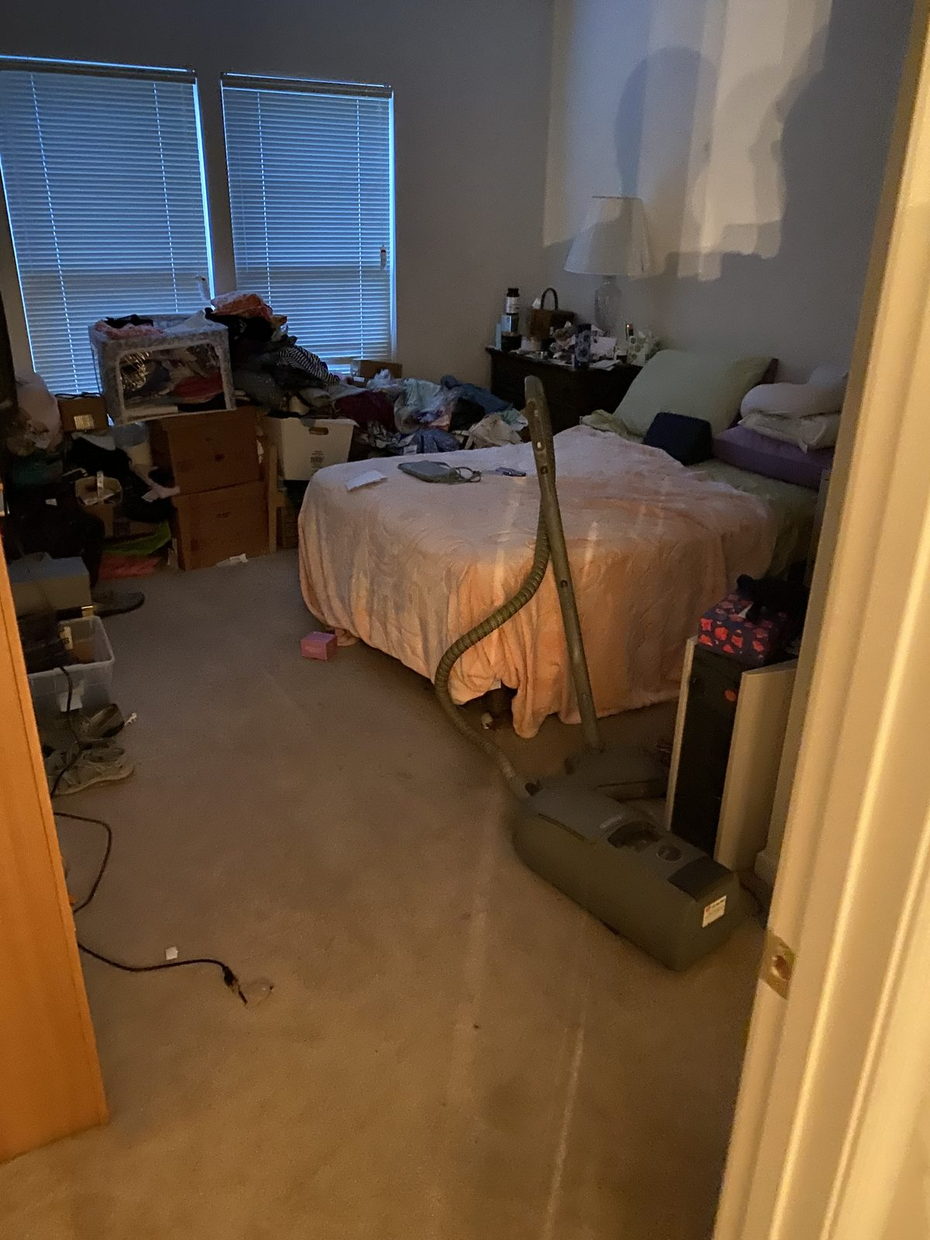 The same bedroom cleared, bed made, carpet vacuumed
